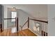 Well-lit staircase with hardwood steps and white railing leading to the upper level at 2455 Kirkstone Dr, Buford, GA 30519