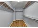 Spacious walk-in closet featuring custom shelving and hardwood floors at 2455 Kirkstone Dr, Buford, GA 30519