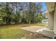 Spacious backyard with a concrete patio and ample green space surrounded by trees at 354 Tarragon Sw Way, Atlanta, GA 30331