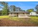 View of backyard with large lawn, concrete patio, and the back exterior of the home at 354 Tarragon Sw Way, Atlanta, GA 30331