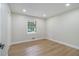 Well-lit bedroom features wood-look flooring and a window allowing natural light at 354 Tarragon Sw Way, Atlanta, GA 30331