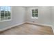 Bright bedroom featuring wood-look flooring and natural light from two windows at 354 Tarragon Sw Way, Atlanta, GA 30331