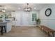 Light-filled dining area featuring stylish lighting and wainscoting, adjacent to the kitchen, perfect for Gathering meals at 354 Tarragon Sw Way, Atlanta, GA 30331