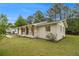 Side view of renovated brick home featuring a well-maintained lawn and ample natural light at 354 Tarragon Sw Way, Atlanta, GA 30331