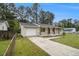 Side view of renovated brick home featuring a garage and well-maintained lawn at 354 Tarragon Sw Way, Atlanta, GA 30331