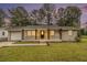 Charming single-story home with covered front porch, brick facade, and manicured lawn at 354 Tarragon Sw Way, Atlanta, GA 30331