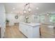 Open concept kitchen and dining area with island, modern light fixtures, and hardwood floors, perfect for entertaining at 354 Tarragon Sw Way, Atlanta, GA 30331