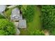 Aerial view of the home showcasing its landscaping, expansive yard, and location surrounded by lush greenery and neighboring properties at 3884 Vic Ar Ct, Peachtree Corners, GA 30360