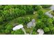 Aerial view showing the property's landscaping, mature trees, and the home's position within a peaceful, leafy neighborhood at 3884 Vic Ar Ct, Peachtree Corners, GA 30360