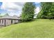 Expansive backyard featuring a gentle slope and mature trees, offering a serene setting for outdoor enjoyment and potential development at 3884 Vic Ar Ct, Peachtree Corners, GA 30360