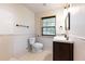 Bathroom featuring a tile shower, toilet, vanity, and window at 3884 Vic Ar Ct, Peachtree Corners, GA 30360