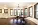 Dining area with dark hardwood floors, a large wood table, and many windows at 3884 Vic Ar Ct, Peachtree Corners, GA 30360