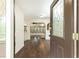 Open entryway with hardwood floors and views into the living space with decorative arches and a ceiling fan at 3884 Vic Ar Ct, Peachtree Corners, GA 30360
