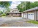 Charming home featuring brick accents, a three-car garage, and an expansive driveway providing ample parking at 3884 Vic Ar Ct, Peachtree Corners, GA 30360