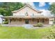 Eye-catching exterior view highlighting the covered porch and beautifully maintained lawn at 3884 Vic Ar Ct, Peachtree Corners, GA 30360