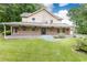 Charming exterior featuring a spacious covered porch, brick accents and lush lawn at 3884 Vic Ar Ct, Peachtree Corners, GA 30360