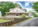 Inviting two-story home with a large front porch and stone retaining wall for added curb appeal at 3884 Vic Ar Ct, Peachtree Corners, GA 30360