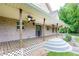 Inviting front porch with brick accents, a welcome sign, and ceiling fans at 3884 Vic Ar Ct, Peachtree Corners, GA 30360