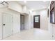 Hallway with neutral tile, access to several closets and an exterior door for convenient entry and storage at 3884 Vic Ar Ct, Peachtree Corners, GA 30360