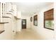 Bright hallway featuring neutral tile, staircase, and exterior door providing easy access to the outside at 3884 Vic Ar Ct, Peachtree Corners, GA 30360