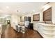 Spacious kitchen with white cabinets, stainless steel appliances, an island with bar seating, and hardwood floors at 3884 Vic Ar Ct, Peachtree Corners, GA 30360