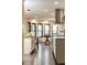 Well-lit kitchen area with modern stainless steel appliances and dark wood floors overlooking a dining space at 3884 Vic Ar Ct, Peachtree Corners, GA 30360