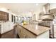 Bright kitchen features a large island, stainless steel appliances, granite countertops, and dark hardwood flooring at 3884 Vic Ar Ct, Peachtree Corners, GA 30360