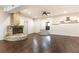 Spacious living room featuring hardwood floors, stone fireplace, and decorative archways leading to the entry and kitchen at 3884 Vic Ar Ct, Peachtree Corners, GA 30360