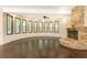 Bright open living room with hardwood floors, a stone fireplace, and plenty of natural light from many windows at 3884 Vic Ar Ct, Peachtree Corners, GA 30360