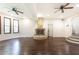 Expansive living room featuring a stone fireplace, ceiling fans, and hardwood flooring at 3884 Vic Ar Ct, Peachtree Corners, GA 30360