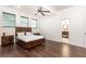 Comfortable bedroom with natural lighting, ceiling fan and dark wood furniture at 3884 Vic Ar Ct, Peachtree Corners, GA 30360