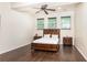 Comfortable bedroom with natural lighting, ceiling fan and dark wood furniture at 3884 Vic Ar Ct, Peachtree Corners, GA 30360