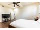 Comfortable bedroom with a TV and dark wood furniture at 3884 Vic Ar Ct, Peachtree Corners, GA 30360