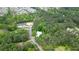 Aerial view of private wooded lot with property lines drawn in and a neighborhood nearby at 132 Picketts Creek Dr, Acworth, GA 30101