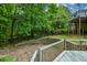 Backyard area with wooden deck, retaining wall, and stairs leading to a home's upper level at 132 Picketts Creek Dr, Acworth, GA 30101