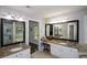 Ensuite bathroom features granite countertops, dual sinks, framed mirrors, and modern lighting fixtures at 132 Picketts Creek Dr, Acworth, GA 30101