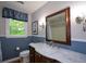 Bathroom boasts a marble countertop, dark wood vanity and a scenic window at 132 Picketts Creek Dr, Acworth, GA 30101