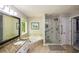 Bathroom with a garden tub, glass shower, and large vanity with granite countertops and a framed mirror at 132 Picketts Creek Dr, Acworth, GA 30101