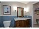 Charming bathroom featuring bead-board accent, marble countertop, and decorative coastal artwork at 132 Picketts Creek Dr, Acworth, GA 30101