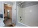 Bright bathroom featuring a tub with shower and tile flooring, perfect for a functional space at 132 Picketts Creek Dr, Acworth, GA 30101