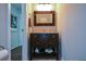 Half bathroom featuring wood trimmed mirror and vanity storage at 132 Picketts Creek Dr, Acworth, GA 30101