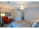 Nicely appointed and comfortable bedroom with an upholstered headboard and leafy green view at 132 Picketts Creek Dr, Acworth, GA 30101