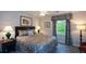 Comfortable bedroom with a queen-sized bed and an upholstered headboard, sitting area, and a leafy green view at 132 Picketts Creek Dr, Acworth, GA 30101