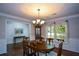Cozy dining room with hardwood floors, chandelier lighting, and classic wainscoting at 132 Picketts Creek Dr, Acworth, GA 30101