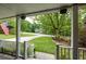 View from the covered front porch with white railings, American flag and view of landscaped front yard at 132 Picketts Creek Dr, Acworth, GA 30101