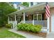 Inviting front porch with white railings, beautiful plants, and comfortable seating at 132 Picketts Creek Dr, Acworth, GA 30101