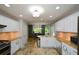 Spacious kitchen with stone tile floors, white cabinets, granite countertops and stainless appliances at 132 Picketts Creek Dr, Acworth, GA 30101
