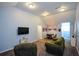 Cozy upstairs living room with plush seating, a TV, and an adjacent dining area at 132 Picketts Creek Dr, Acworth, GA 30101