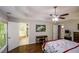 Large primary bedroom boasts a tray ceiling, hardwood floors, and an ensuite bathroom with a soaking tub at 132 Picketts Creek Dr, Acworth, GA 30101