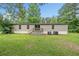 Back of home with a back porch featuring a wide green lawn showcasing the outdoor space at 170 White Rose Ln, Temple, GA 30179